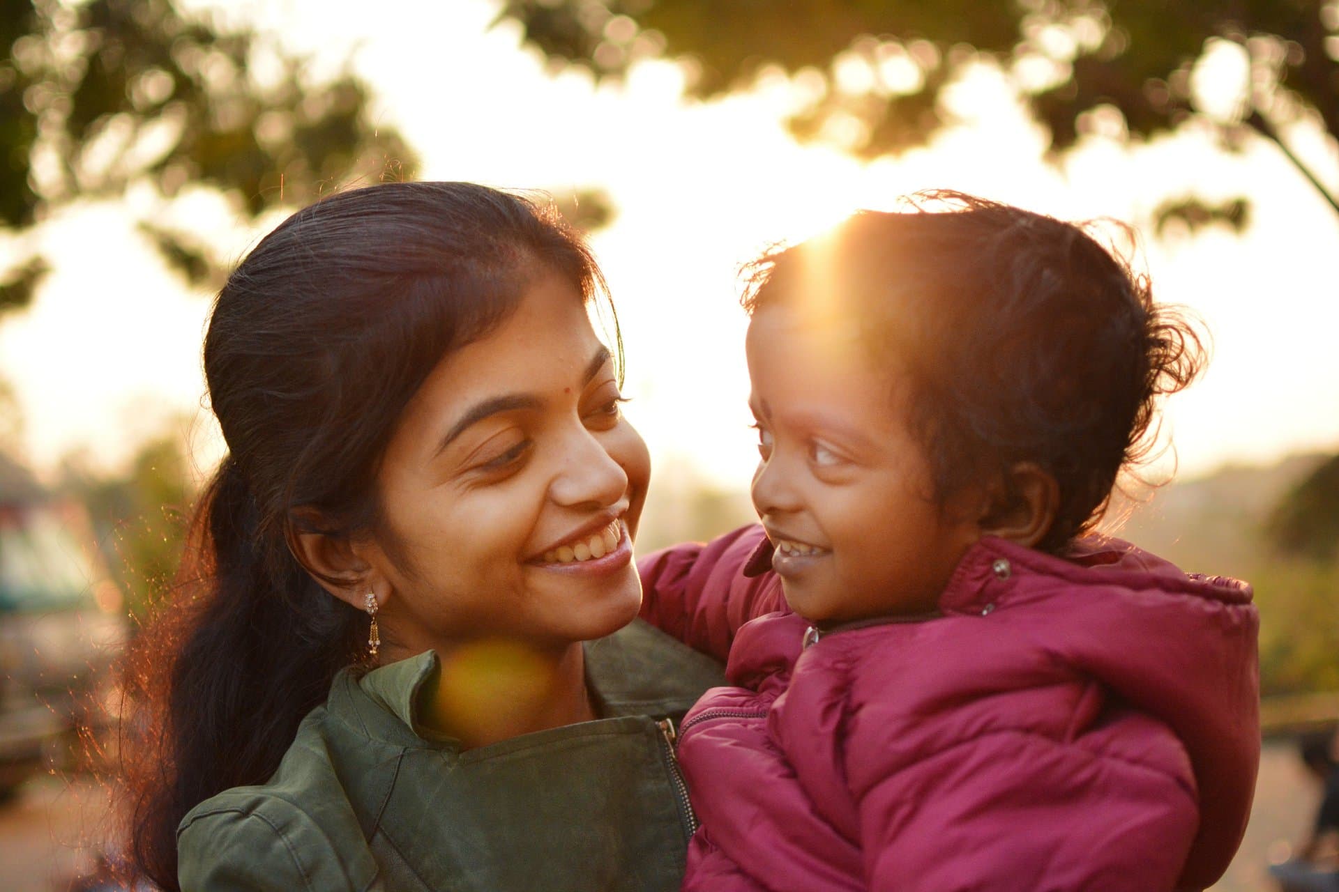A mother and daughter smiling together